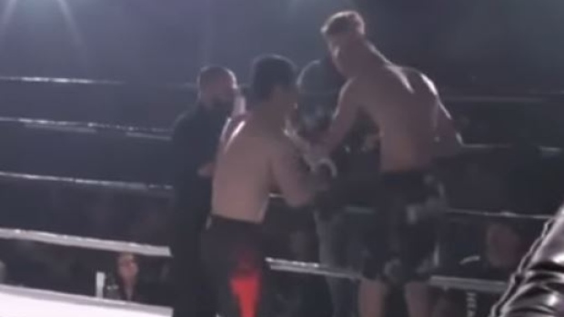 MMA fighter Paata Tschapelia pulls opponent Arkadiusz Wroblewski's shoulder back into place.