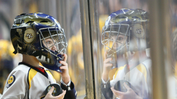 A young predators fan watches his team in action