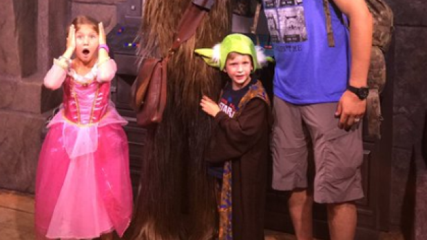 The Burns family poses in a hilarious family photo with Chewbacca at Disney World.