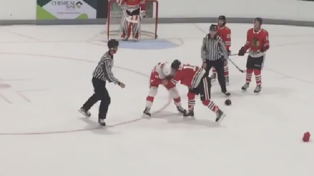 Alex DeBrincat and Dylan Sadowy fight during a prospects game between Chicago and Detroit.