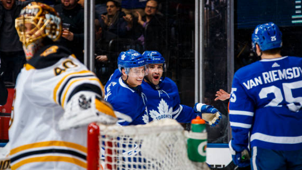 Toronto Maple Leafs players celebrate a goal against the Boston Bruins.