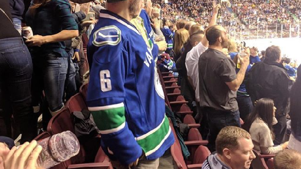 A Vancouver Canucks fans watches his team in action.
