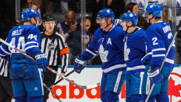 Toronto Maple Leafs players celebrate a goal.