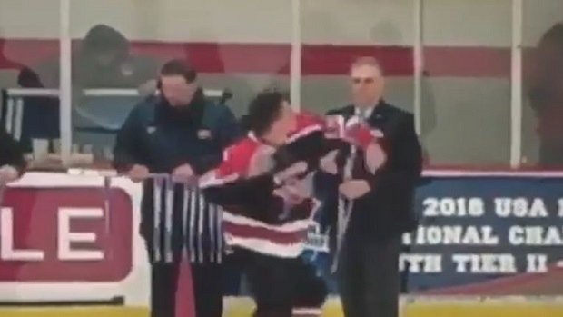 Junior hockey player tosses his medal