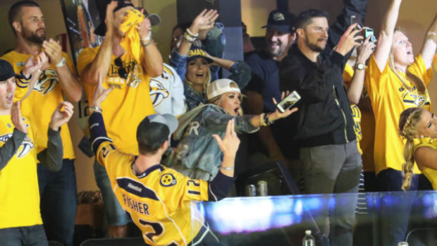 Carrie Underwood celebrates with fans during a Nashville Predators 2017 postseason game.