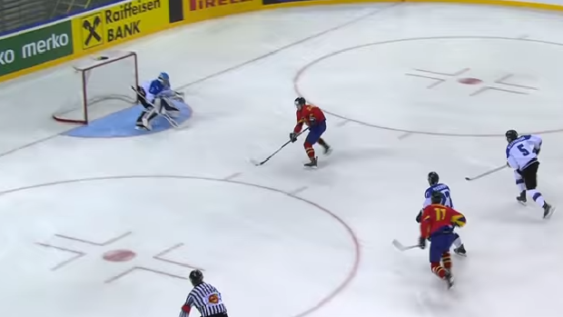 A Romanian player passes on a breakaway during the Group B IIHF World Hockey Championships.
