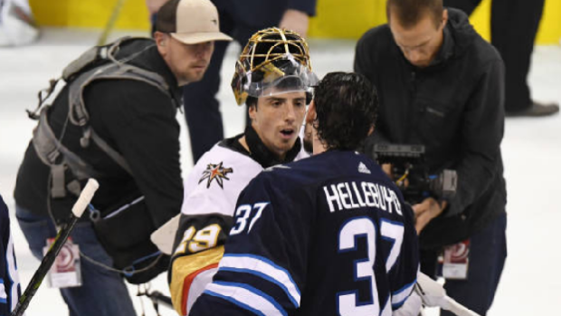 Marc-Andre Fleury shakes hands with Connor Hellebuyck.