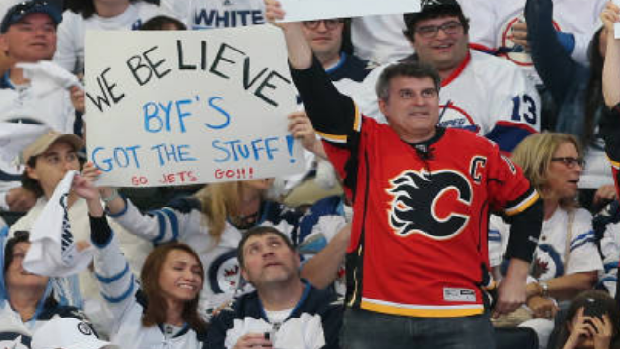 A Calgary Flames fan cheers on the Winnipeg Jets during Game 5 of the Western Conference Finals.