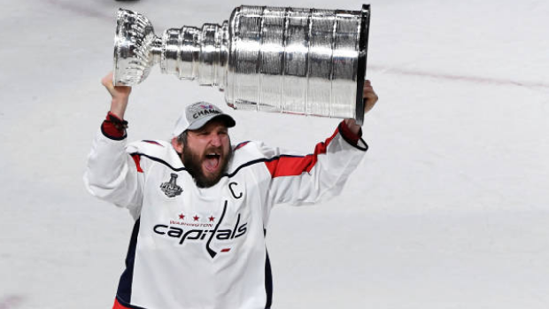 Alex Ovechkin lifts the Stanley Cup.