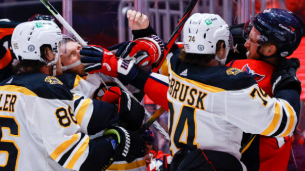 Boston Bruins and Washington Capitals players battle