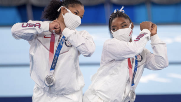 Simone Biles and Jordan Chiles react after receiving their silver medals during the Team final.