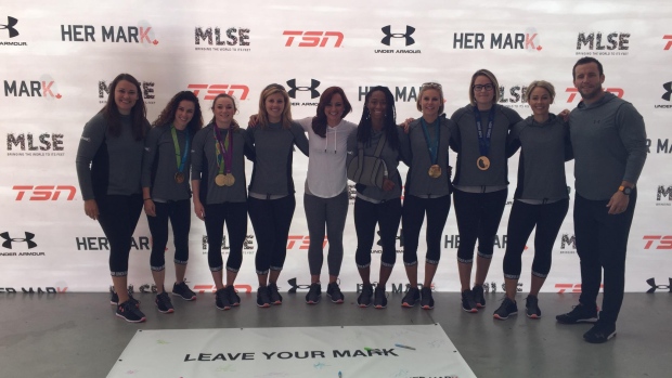 Kate Beirness poses with participants at the HER MARK summit.
