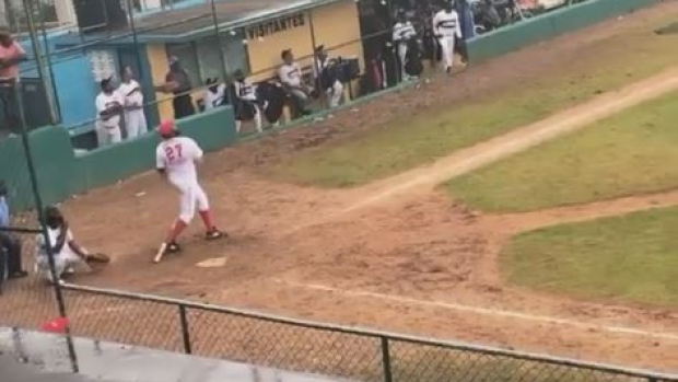 Vladimir Guerrero crushes a ball during a softball game.