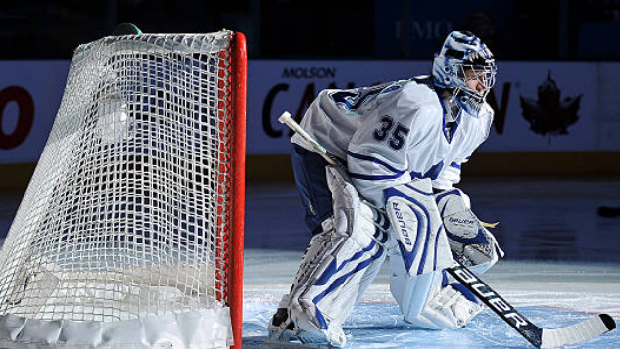 Toronto Maple Leafs goalie Vesa Toskala, left, wearing a